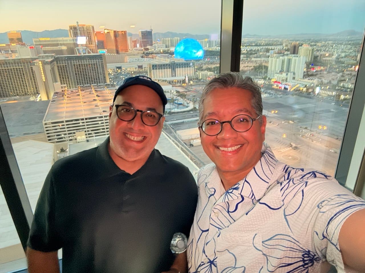 Gardy and Richie taking a golden hour selfie with the Sphere behind them
