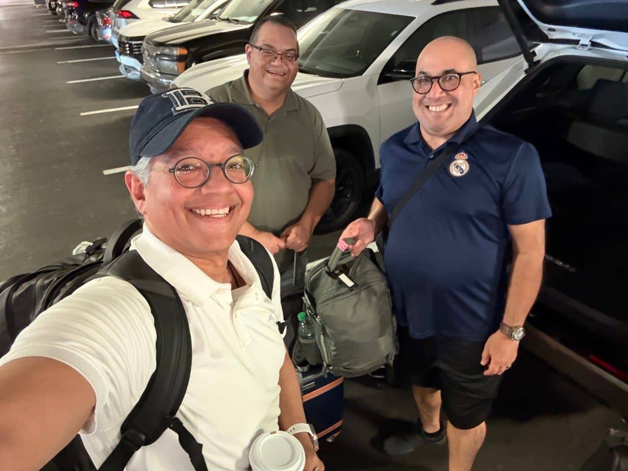Richie, Alejo, and Gardy reuniting in the Elara parking garage with luggage