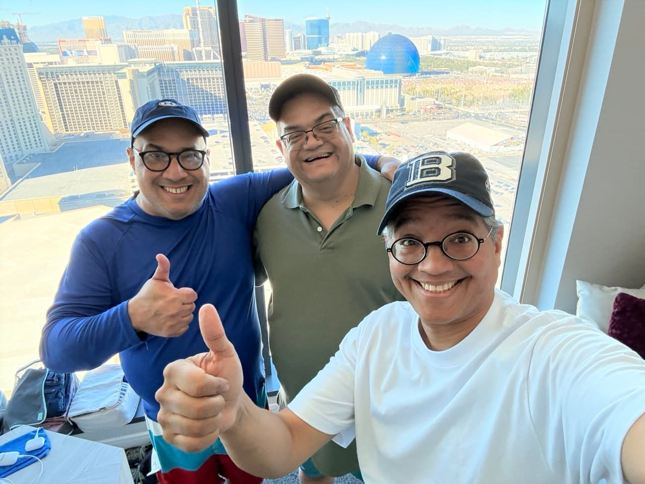 Gardy, Alejo, and Richie ready for the pool with the Sphere visible through the window