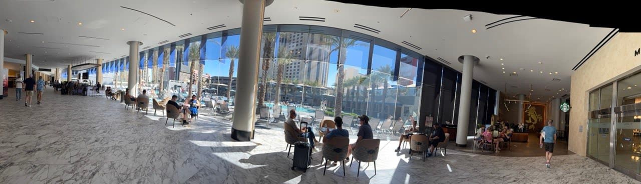 Panoramic view from the Elara lobby leading toward the pool