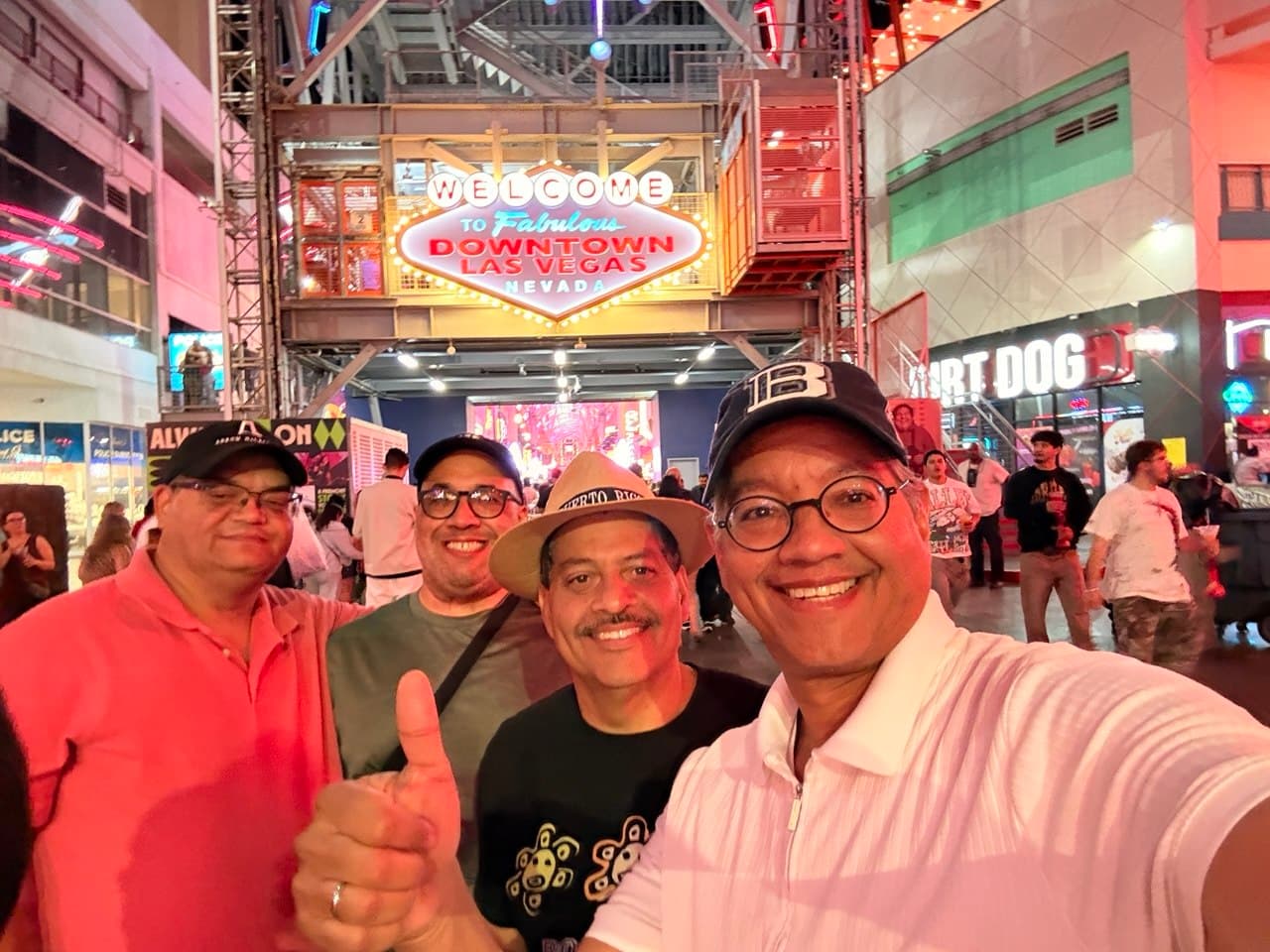 The four friends under the Welcome to Fabulous Downtown Las Vegas sign at night