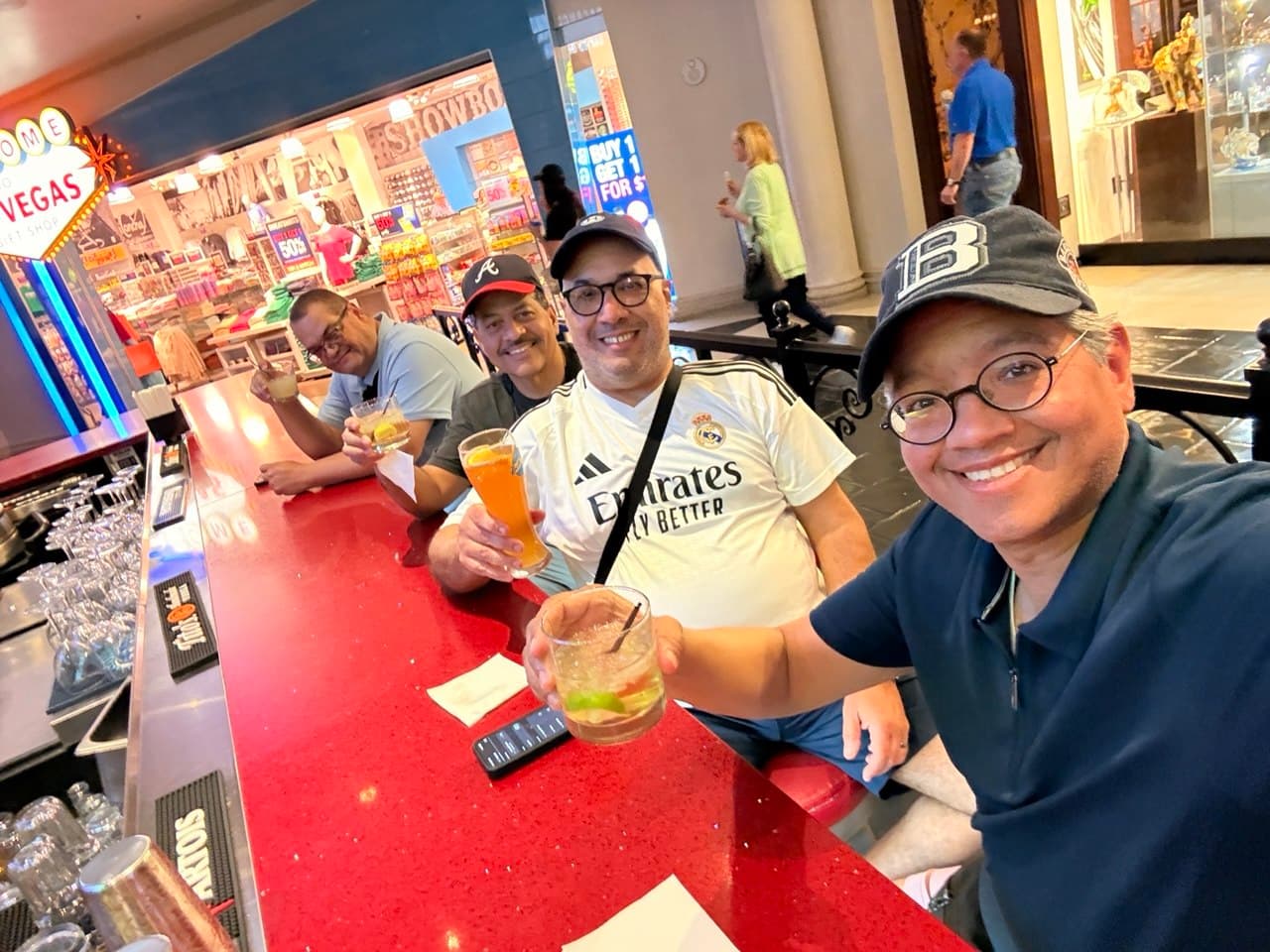 The four friends with cocktails in a Caesars bar