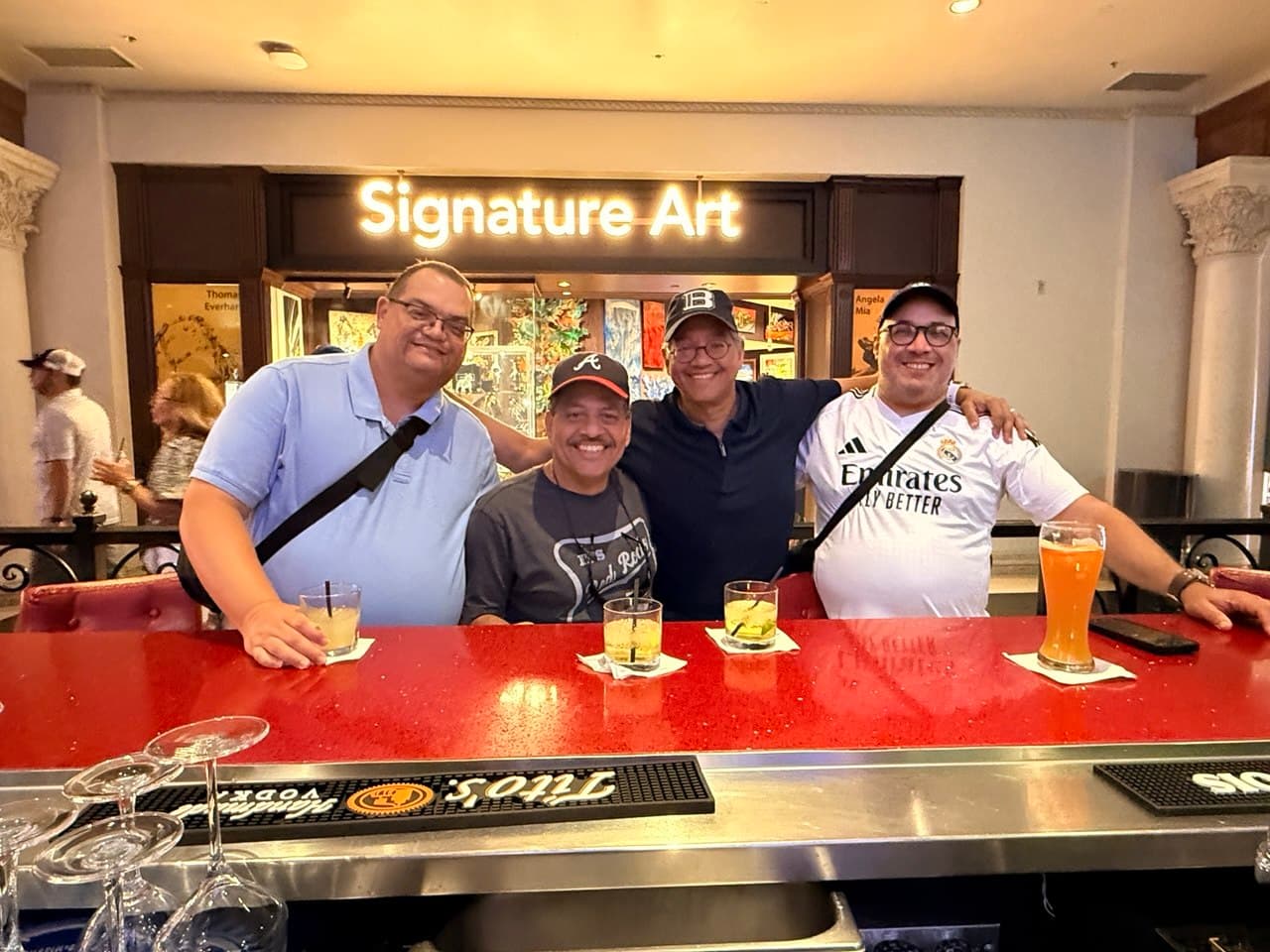 The four friends photographed from behind the bar at Caesars
