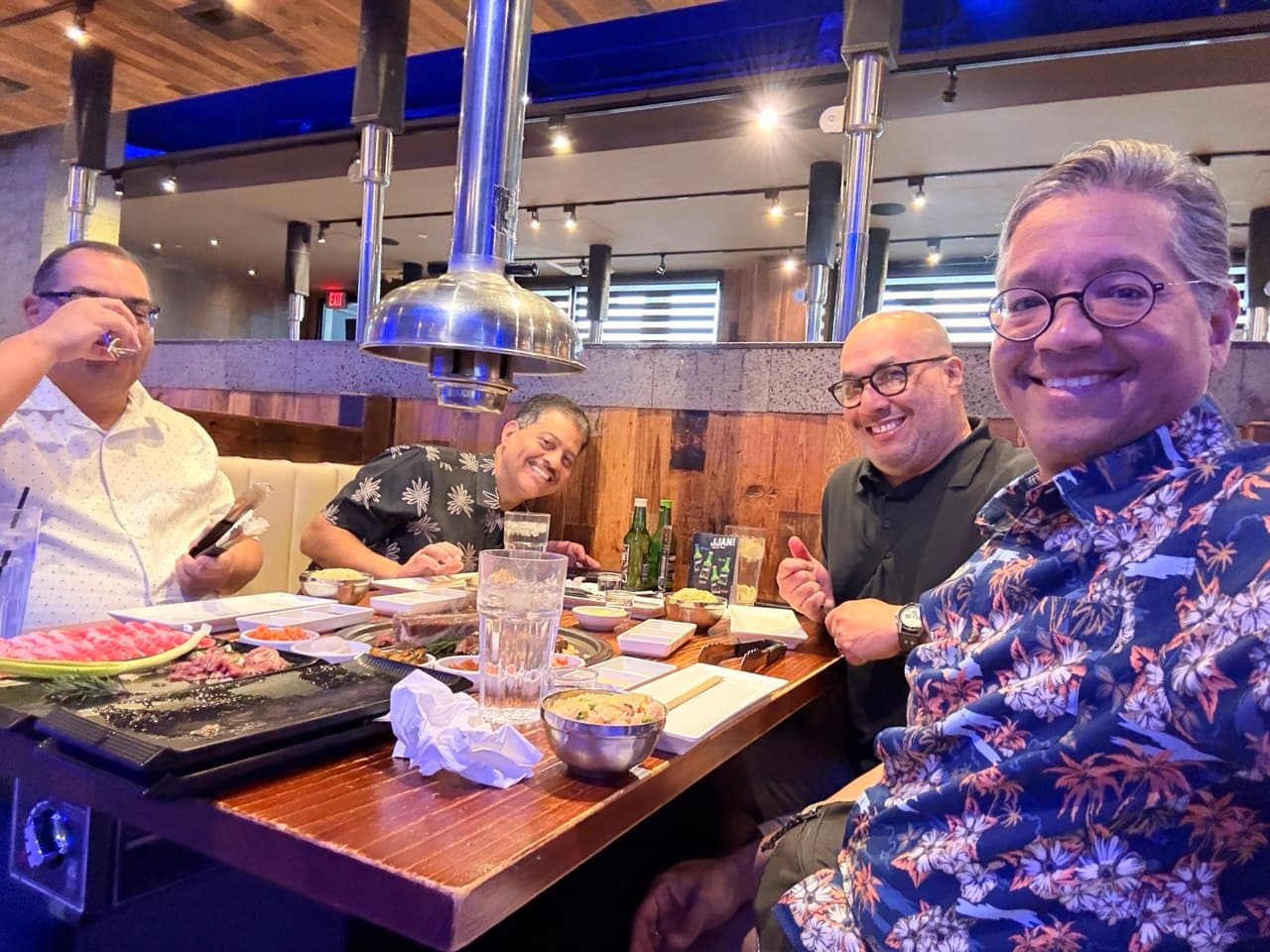 All four friends eating Korean BBQ together