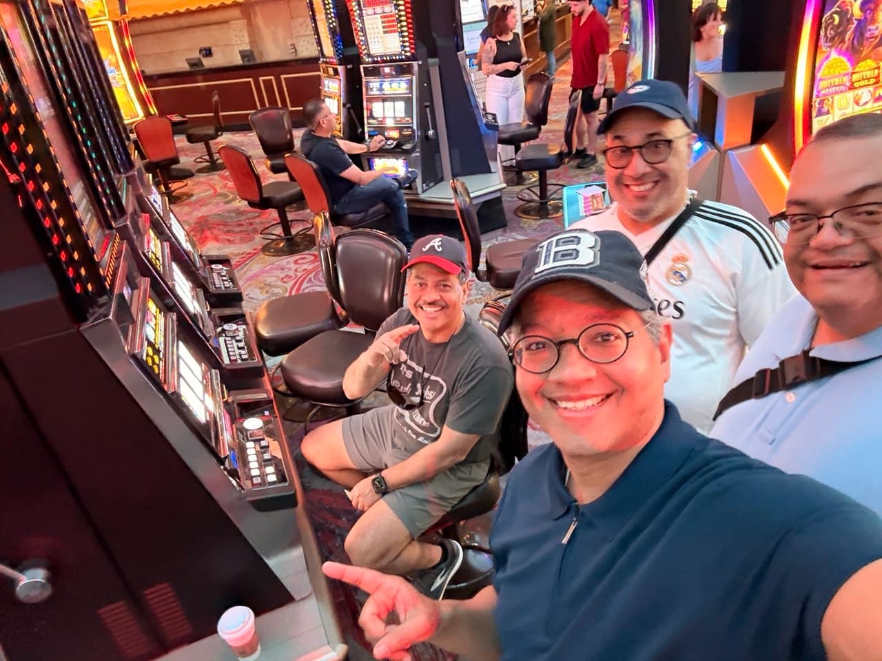 All four friends at the slot machines in the casino