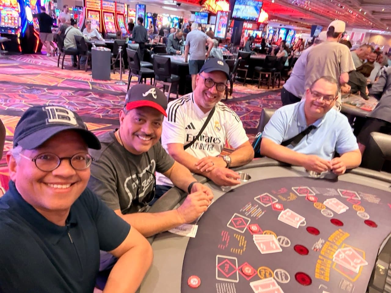 The four friends sitting together at a poker table in Las Vegas