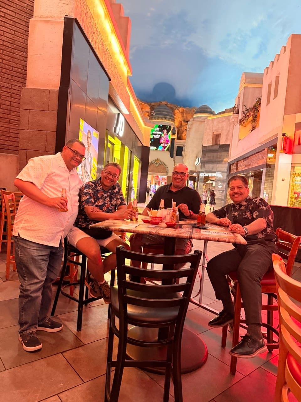 The four friends sharing Coronas at a Mexican bar near the Elara