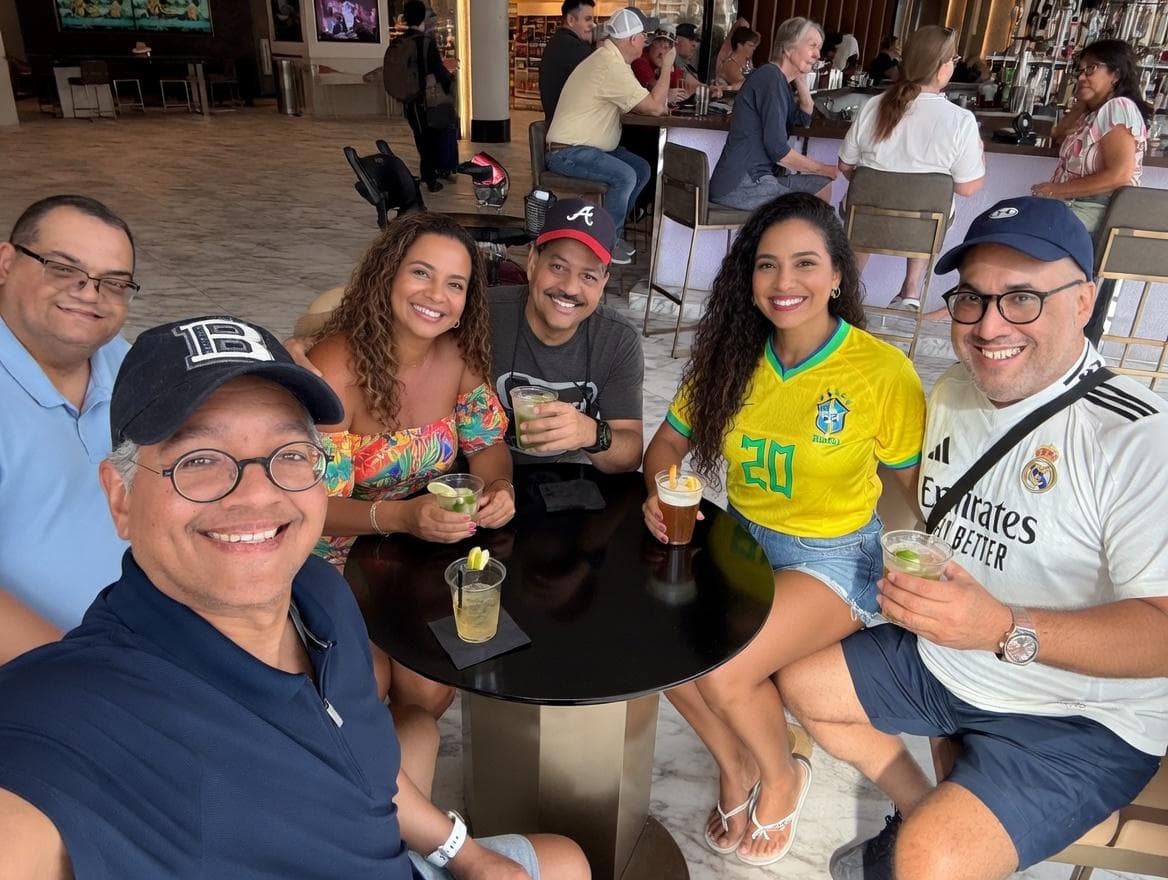 Second AI image of the group at the lobby bar with the same women in new outfits